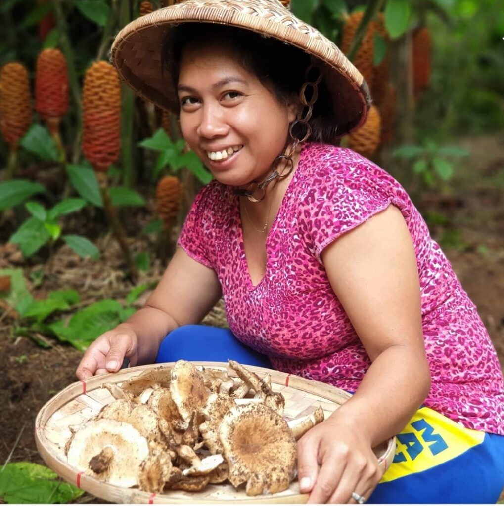 A woman at the Maka Forest Villa holding a tray of mushrooms