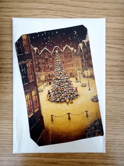 old Christmas card with a Christmas tree in the center